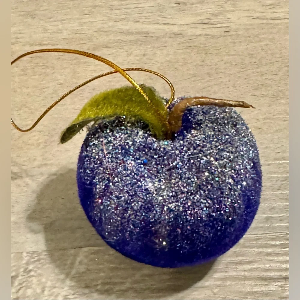 Christmas tree ornament. A plum-shaped ornament covered in glitter. The ornament